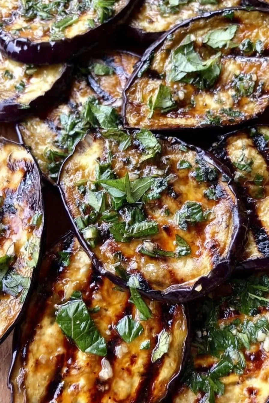 Char-grilled slices of eggplant garnished with parsley and lemon, ready to serve